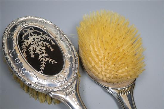 A George V silver and tortoiseshell pique mounted timepiece, S.W. Goode & Co, Chester, 1920, 10cm and a similar toilet set(a.f.)